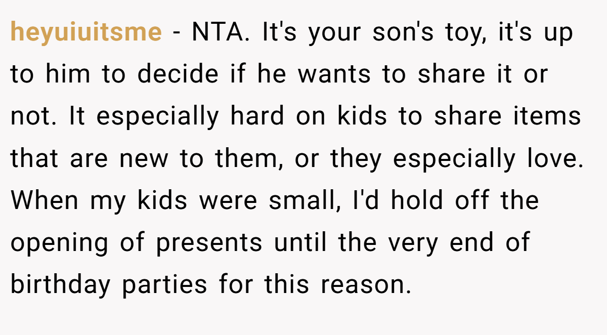 heyuiuitsme − NTA. It's your son's toy, it's up to him to decide if he wants to share it or not. It especially hard on kids to share items that are new to them, or they especially love. When my kids were small, I'd hold off the opening of presents until the very end of birthday parties for this reason.