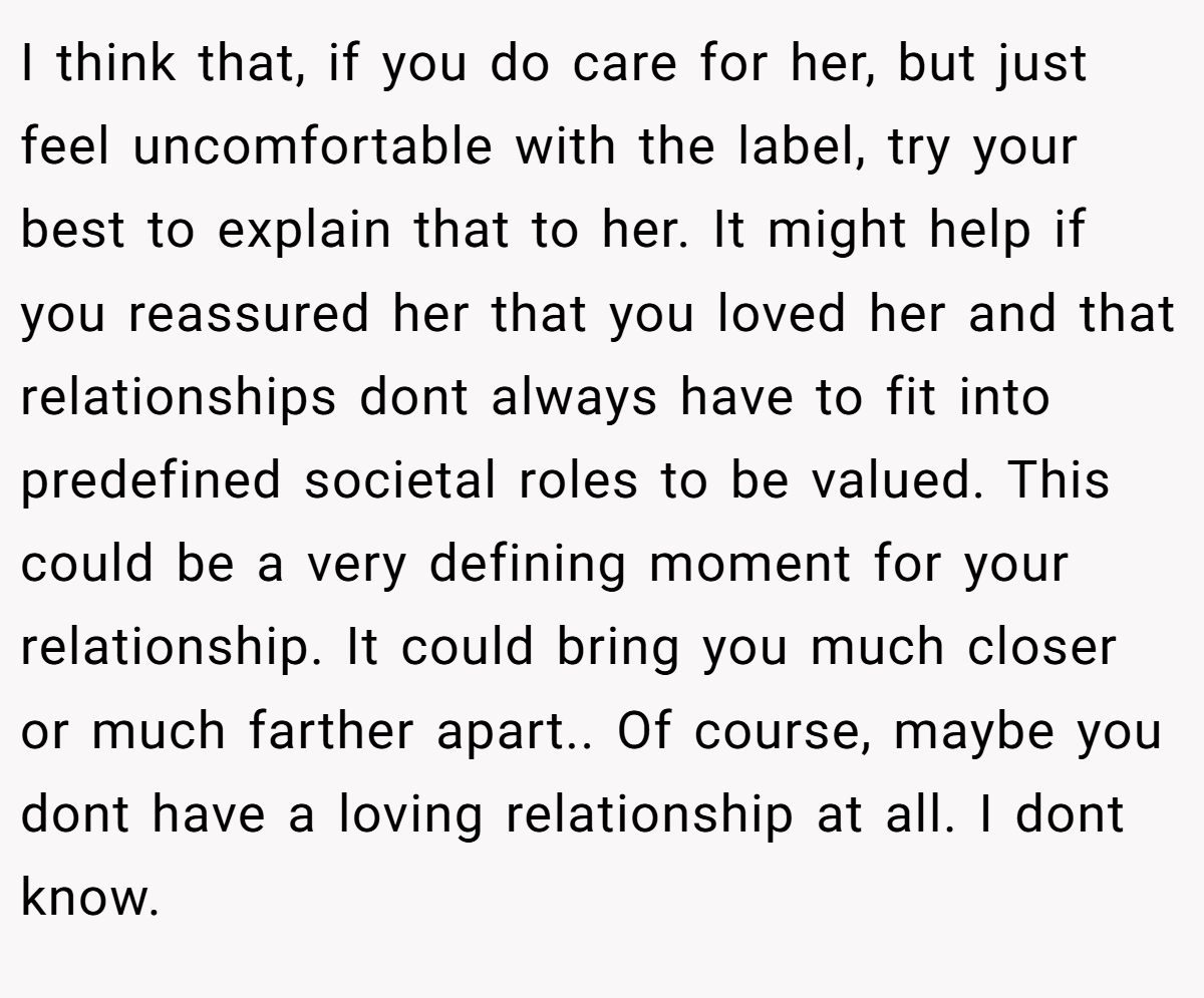 She likely is feeling rejected, and is lashing out immaturely.  Not right, but not malicious, either. I think that, if you do care for her, but just feel uncomfortable with the label, try your best to explain that to her.