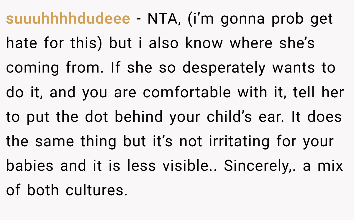 suuuhhhhdudeee − NTA, (i’m gonna prob get hate for this) but i also know where she’s coming from. If she so desperately wants to do it, and you are comfortable with it, tell her to put the dot behind your child’s ear. It does the same thing but it’s not irritating for your babies and it is less visible.. Sincerely,. a mix of both cultures.