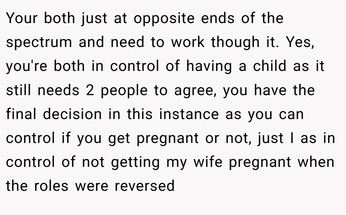 Your both just at opposite ends of the spectrum and need to work though it. Yes, you're both in control of having a child as it still needs 2 people to agree, you have the final decision in this instance as you can control if you get pregnant or not, just I as in control of not getting my wife pregnant when the roles were reversed