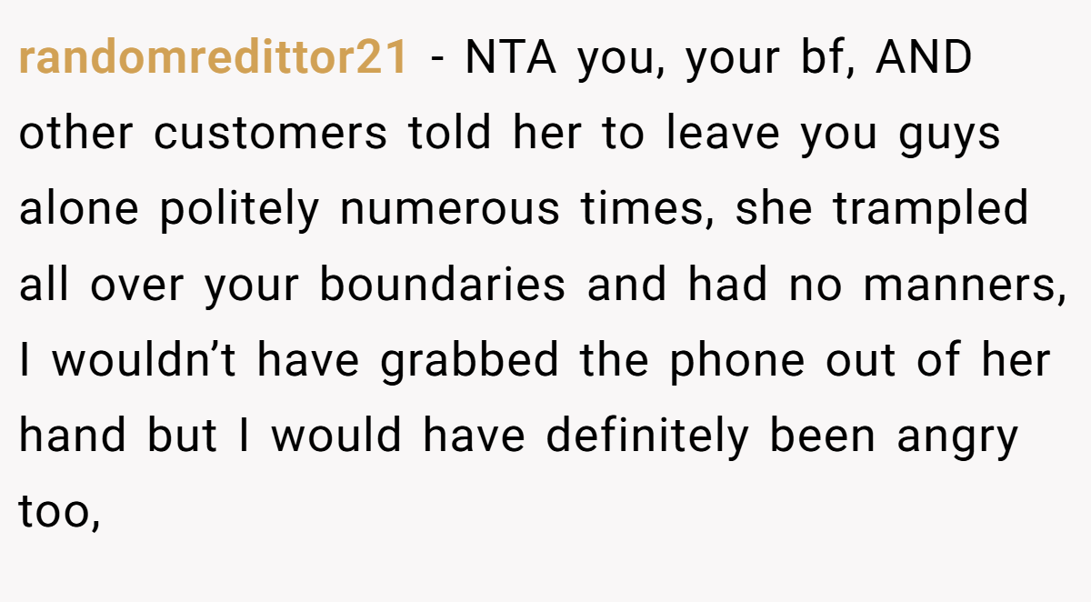 randomredittor21 - NTA you, your bf, AND other customers told her to leave you guys alone politely numerous times, she trampled all over your boundaries and had no manners, I wouldn’t have grabbed the phone out of her hand but I would have definitely been angry too,