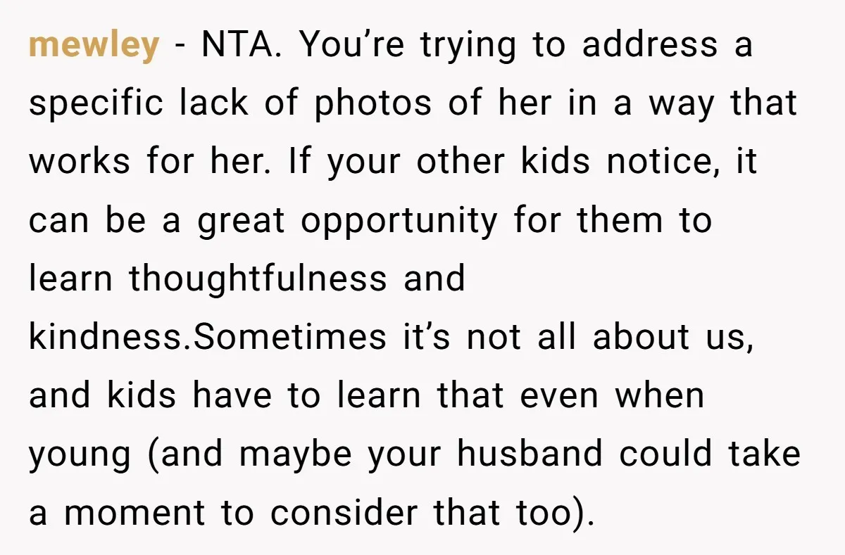 mewley − NTA. You’re trying to address a specific lack of photos of her in a way that works for her. If your other kids notice, it can be a...
