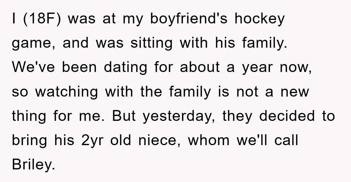 I (18F) was at my boyfriend's hockey game, and was sitting with his family. We've been dating for about a year now, so watching with the family is not a...