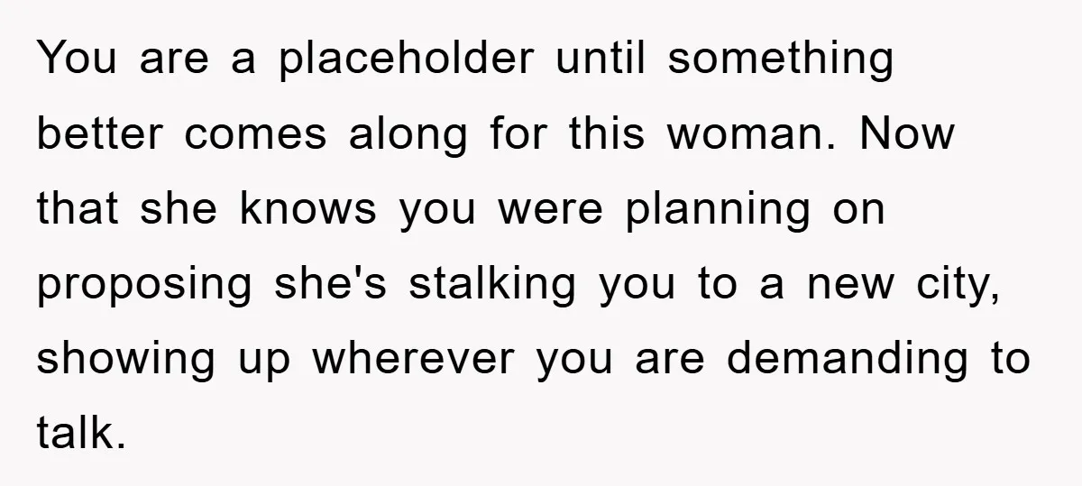 You are a placeholder until something better comes along for this woman. Now that she knows you were planning on proposing she's stalking you to a new city, showing up...