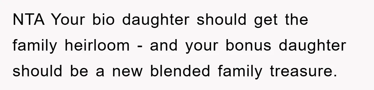 NTA Your bio daughter should get the family heirloom - and your bonus daughter should be a new blended family treasure.