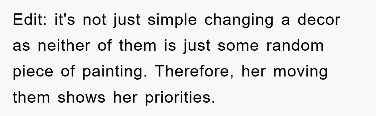 Edit: it's not just simple changing a decor as neither of them is just some random piece of painting. Therefore, her moving them shows her priorities.