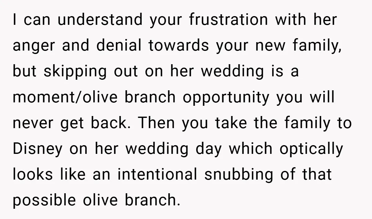 I can understand your frustration with her anger and denial towards your new family, but skipping out on her wedding is a moment/olive branch opportunity you will never get back....