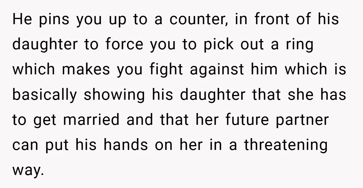 He pins you up to a counter, in front of his daughter to force you to pick out a ring which makes you fight against him which is basically showing...