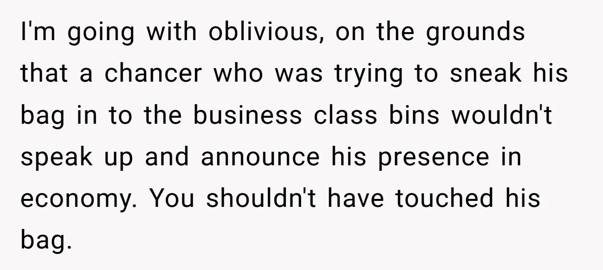 I'm going with oblivious, on the grounds that a chancer who was trying to sneak his bag in to the business class bins wouldn't speak up and announce his presence...
