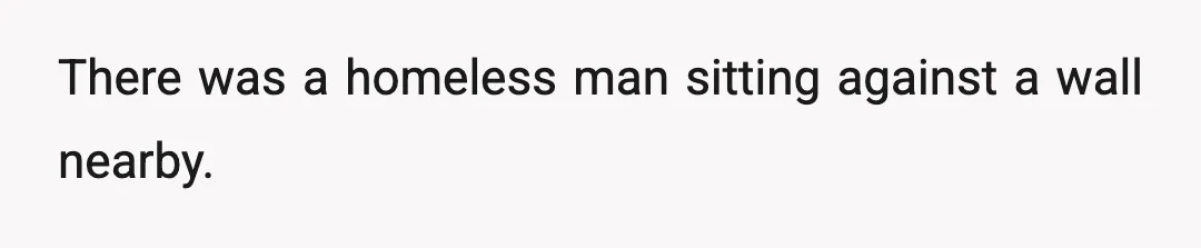 There was a homeless man sitting against a wall nearby.