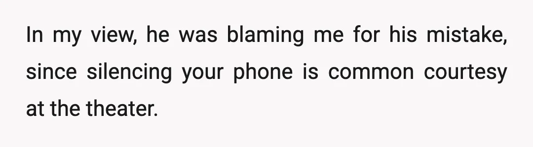 In my view, he was blaming me for his mistake, since silencing your phone is common courtesy at the theater.